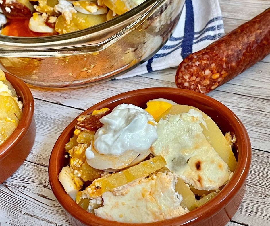 Layered potatoes with sausage and eggs